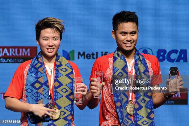 Gold medalist Tontowi Ahmad and Liliyana Natsir of Indonesia celebrate on the podium during Mixed Double medals ceremony of the BCA Indonesia Open...