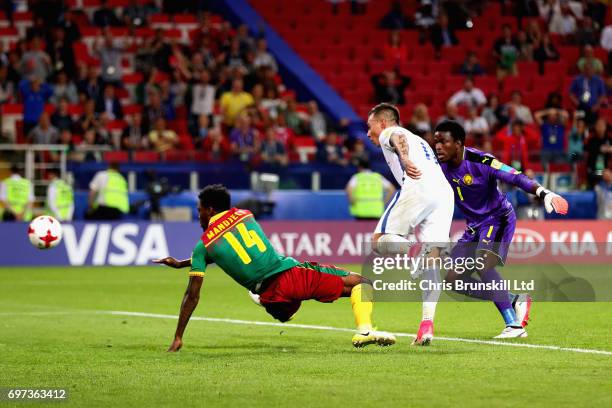 Eduardo Vargas of Chile puts the ball past Fabrice Ondoa of Cameroon and Georges Mandjeck of Cameroon to score the second goal for Chile during the...