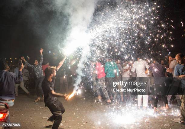 Kashmiri people celebrate after Pakistan's win in the ICC Champions Trophy final cricket match against India Sunday, June 18 in the old city of...