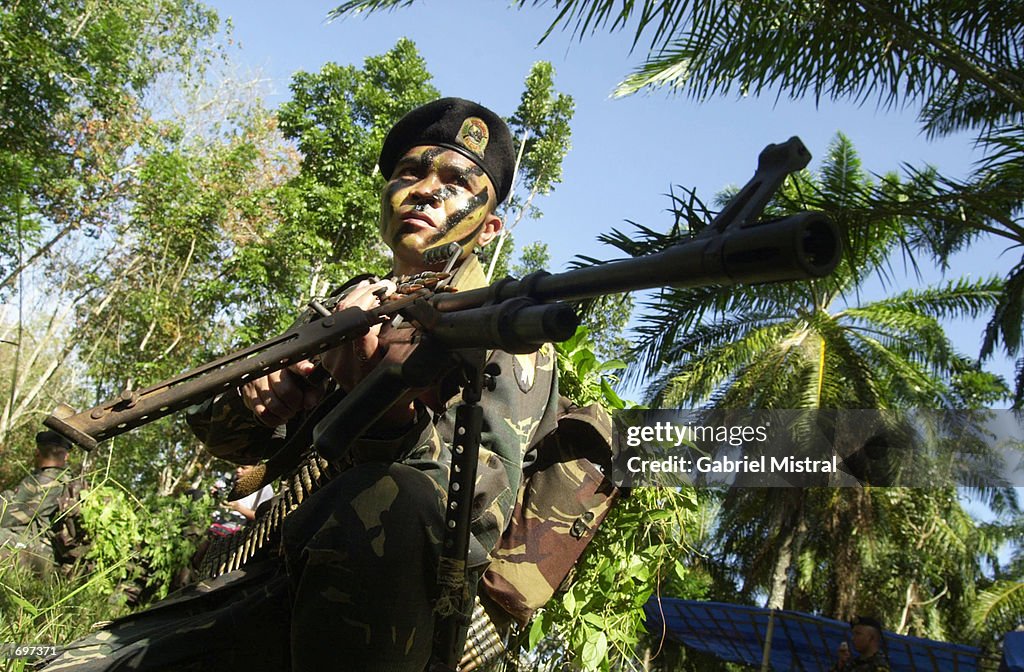 A Filipino elite Scout Ranger aims his rifle at a target during a ...
