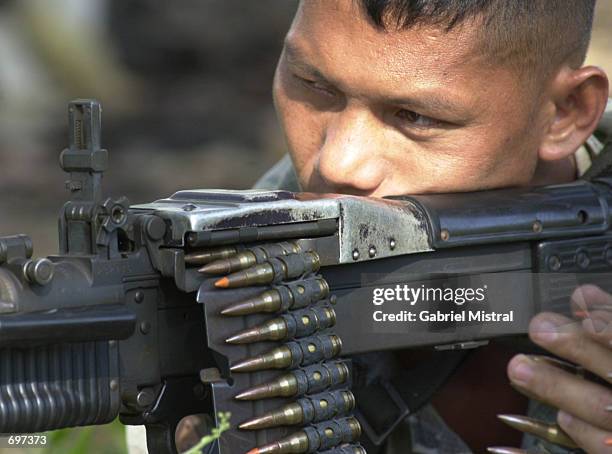 An elite Filipino Scout Ranger aims his M60 machine gun at a target during a mock exercise February 3, 2002 in a ranger camp in Cabunbata, Basilan on...