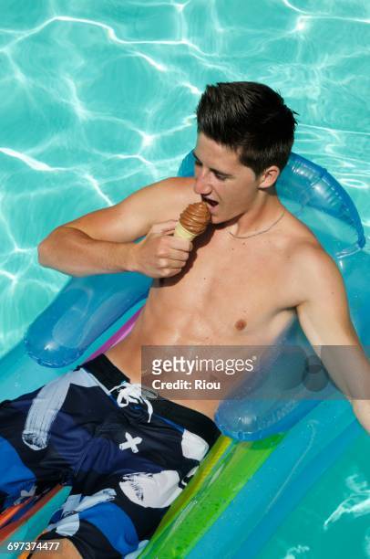 boy with a ice cream - pool raft imagens e fotografias de stock