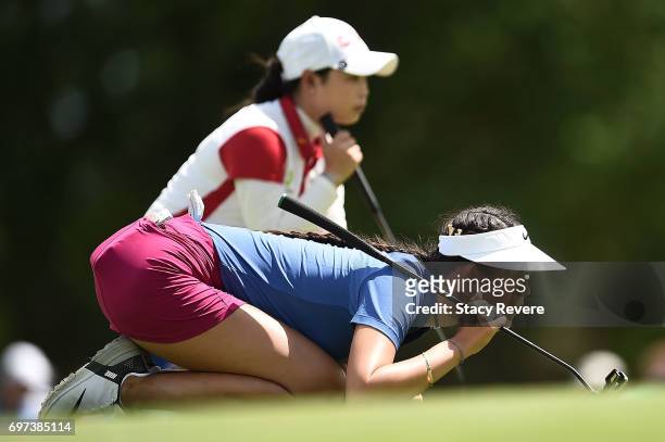 Michelle Wie and Moriya Jutanugarn of Thailand read the green on the 17th hole during the final round of the Meijer LPGA Classic at Blythefield...