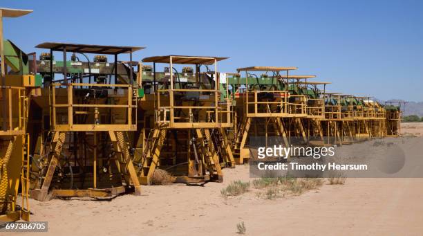 row of parked cotton baling machines - blythe brown stock-fotos und bilder
