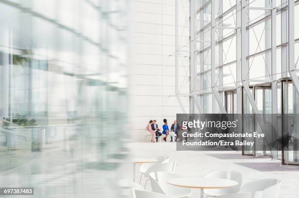 business people having meeting in modern lobby - cef do not delete stock pictures, royalty-free photos & images