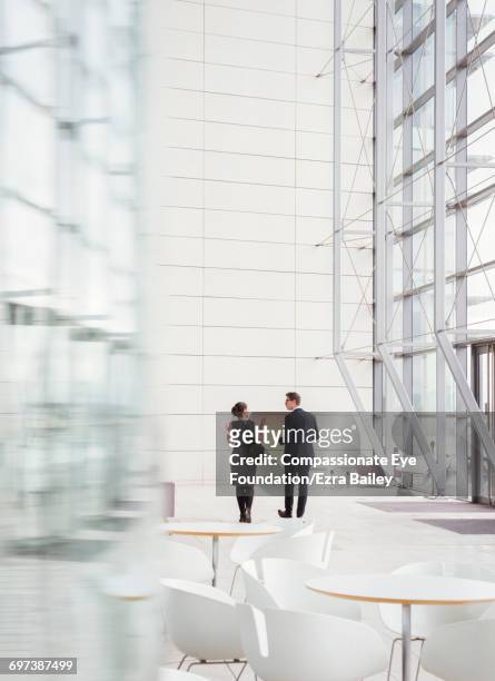 business people talking in modern lobby - cef do not delete stock pictures, royalty-free photos & images