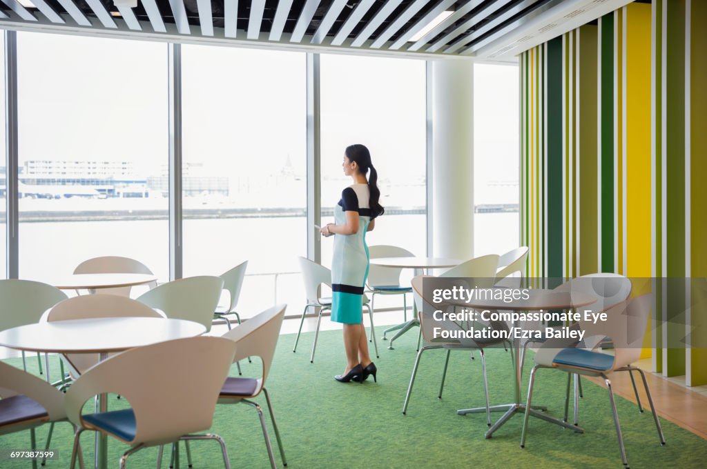 Businesswoman looking out of window in cafe