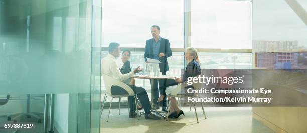 businessman talking in meeting in office - presidente de organización fotografías e imágenes de stock