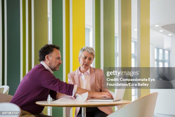 business people discussing plans in cafe - two executive man coffee shop stock pictures, royalty-free photos & images