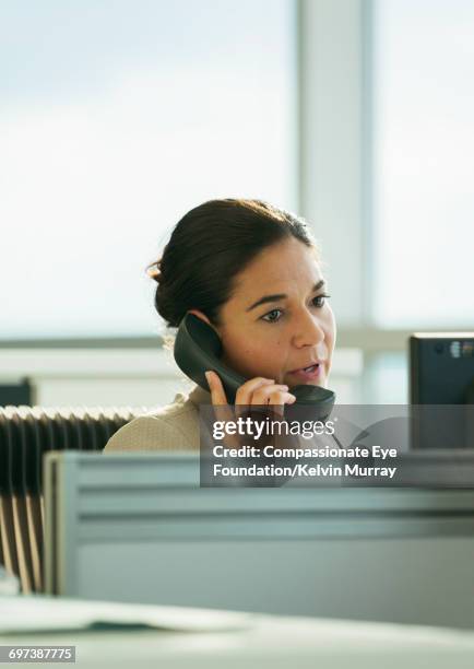 businesswoman talking on phone in office - landline phone woman stock pictures, royalty-free photos & images