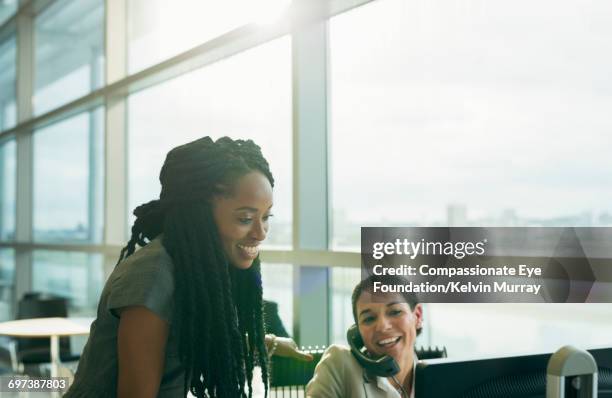 business people reviewing project in office - african cornrow braids stock pictures, royalty-free photos & images