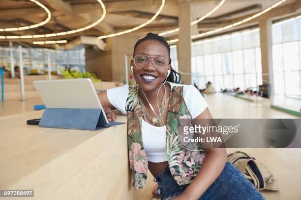 smiling female college student with digital tablet - three quarter length stock pictures, royalty-free photos & images