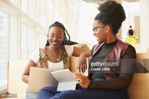 university friends working together - leanincollection stock pictures, royalty-free photos & images