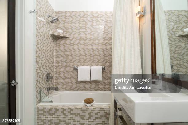 modern tiled bathroom with shower and vanity - hotel bathroom stock pictures, royalty-free photos & images