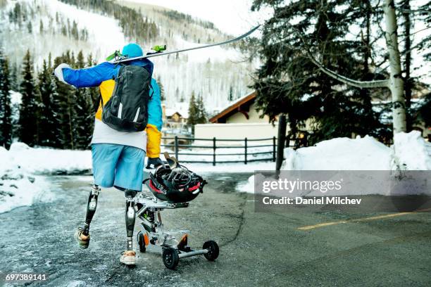 man with prosthetics and wheelchair sled. - prothese stock-fotos und bilder