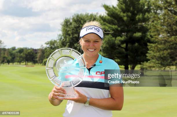 Brooke M. Henderson of Canada holds up the trophy after winning the Meijer LPGA Classic during the final round of the Meijer LPGA Classic held at...