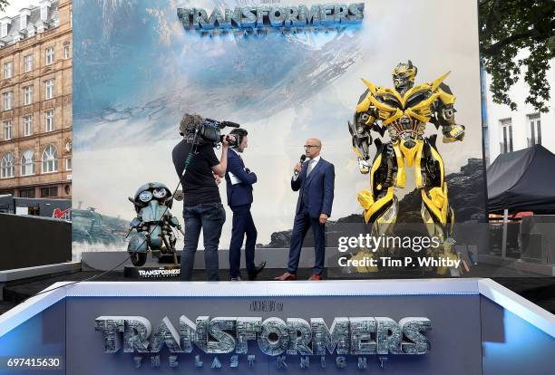 Alex Zane and Stanley Tucci on stage at the global premiere of "Transformers: The Last Knight" at Cineworld Leicester Square on June 18, 2017 in...