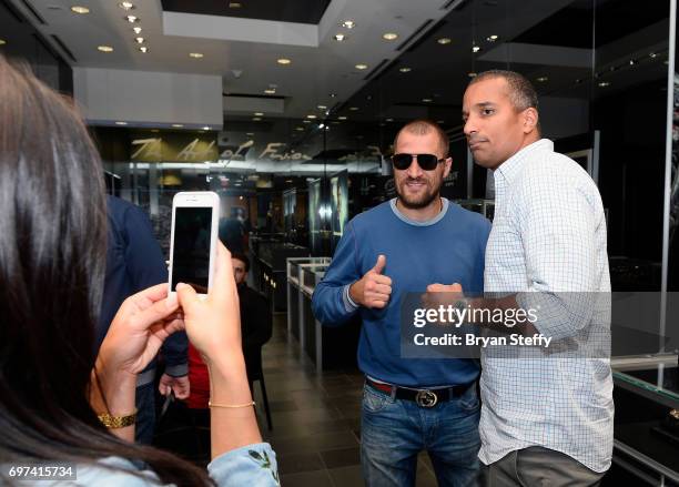 Boxer and Hublot ambassador Sergey Kovalev poses with a fan during his visit to the Hublot Boutique at The Forum Shops at Caesars on June 18, 2017 in...
