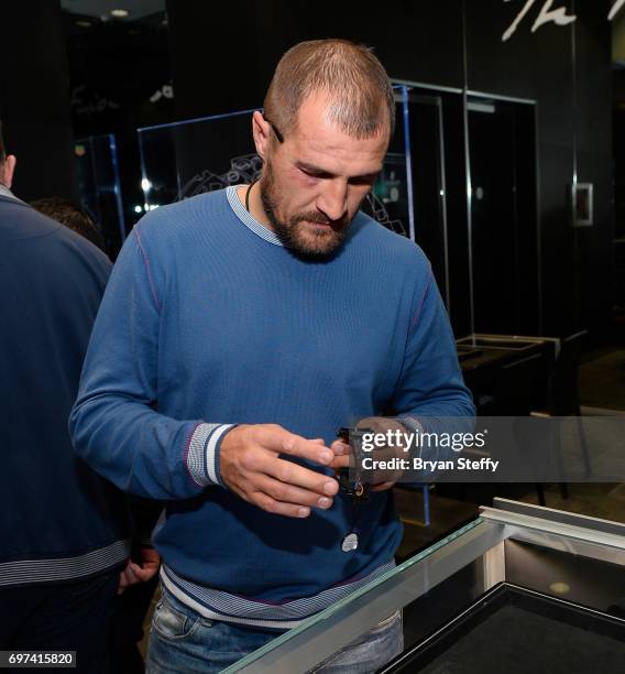 Boxer and Hublot ambassador Sergey Kovalev examines the Hublot Big Bang Broderie Sugar Skull watch during his visit to the Hublot Boutique at The...