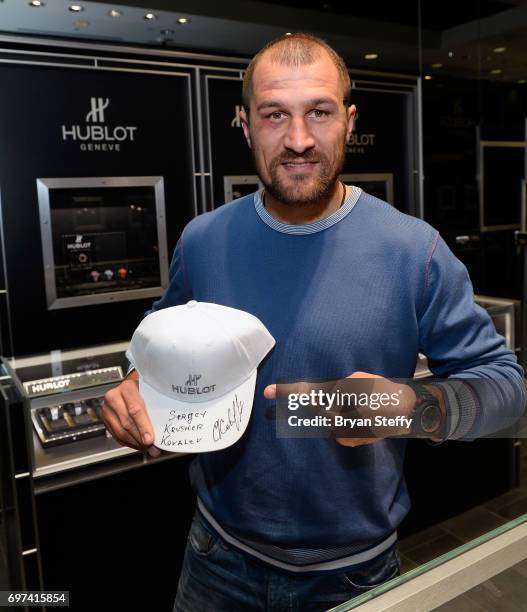 Boxer and Hublot ambassador Sergey Kovalev autographs Hublot baseball hats during his visit to the Hublot Boutique at The Forum Shops at Caesars on...