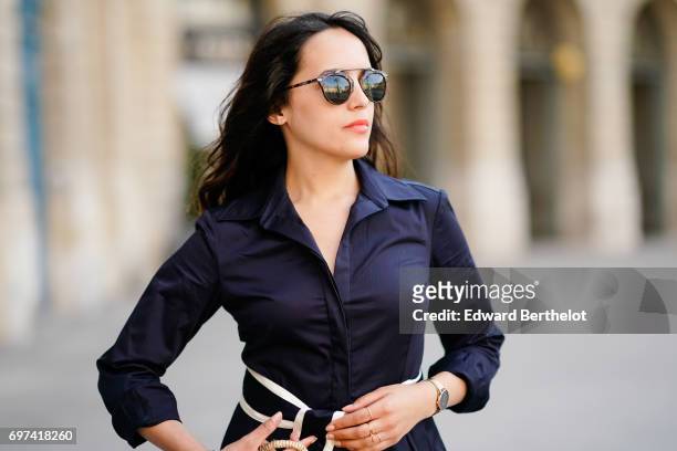 Sarah Benziane, fashion blogger, wears an El Ganso ruffled dress with a belt, a basket made of straw, sunglasses, and Zara white shoes, on June 17,...