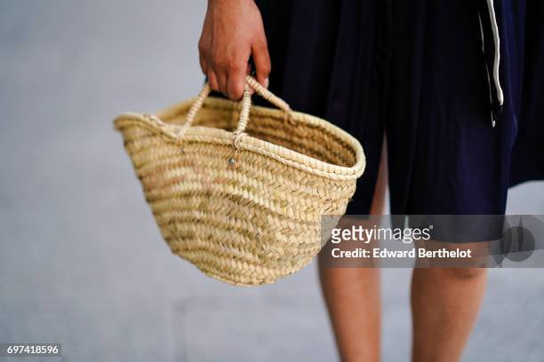 Sarah Benziane, fashion blogger, wears an El Ganso ruffled dress with a belt, a basket made of straw, sunglasses, and Zara white shoes, on June 17,...