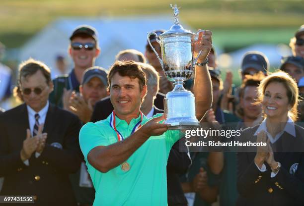 Brooks Koepka of the United States poses with the winner's trophy after his victory at the 2017 U.S. Open at Erin Hills on June 18, 2017 in Hartford,...