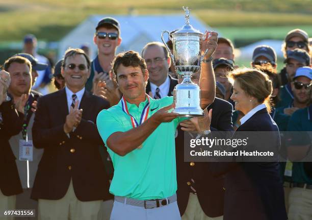 Brooks Koepka of the United States poses with the winner's trophy after his victory at the 2017 U.S. Open at Erin Hills on June 18, 2017 in Hartford,...