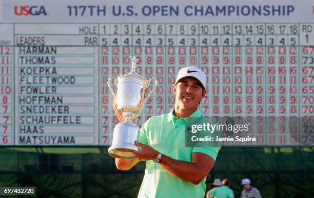 Brooks Koepka of the United States poses with the winner's trophy after his victory at the 2017 U.S. Open at Erin Hills on June 18, 2017 in Hartford,...