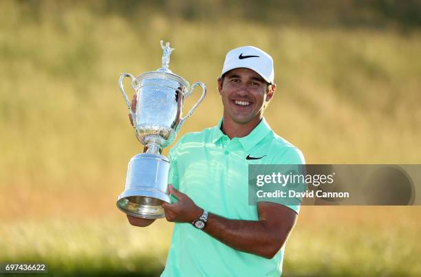 Brooks Koepka of the United States holds the U.S.Open trophy after his four shot win in the final round of the 117th US Open Championship at Erin...