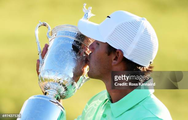 Brooks Koepka of the United States kisses the winner's trophy after his victory at the 2017 U.S. Open at Erin Hills on June 18, 2017 in Hartford,...
