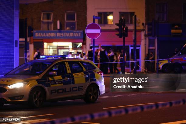 Police take security measures after a vehicle plowed into pedestrians on the sidewalk near the Finsbury Park Mosque on Seven Sisters Road in London,...