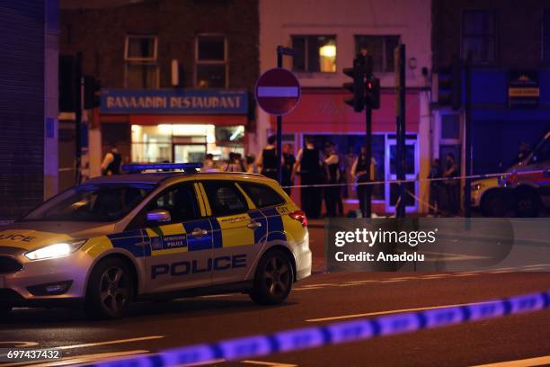 Police take security measures after a vehicle plowed into pedestrians on the sidewalk near the Finsbury Park Mosque on Seven Sisters Road in London,...