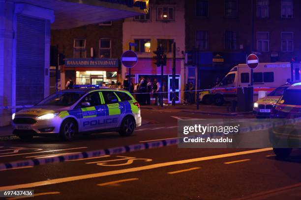 Police take security measures after a vehicle plowed into pedestrians on the sidewalk near the Finsbury Park Mosque on Seven Sisters Road in London,...