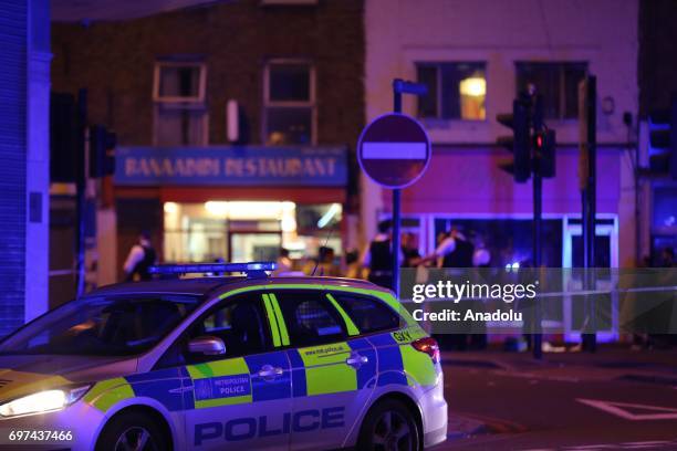Police take security measures after a vehicle plowed into pedestrians on the sidewalk near the Finsbury Park Mosque on Seven Sisters Road in London,...