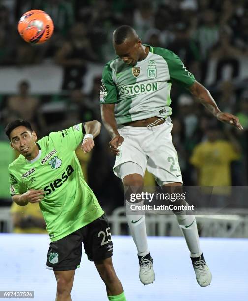 Edwin Velasco of Nacional jumps for a header with Fabian Sambueza of Deportivo Cali during the Final second leg match between Atletico Nacional and...