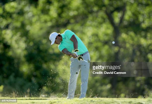 Brooks Koepka of the United States plays his tee shot at the par 3, 16th hole during the final round of the 117th US Open Championship at Erin Hills...
