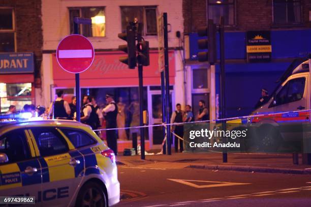 Police take security measures after a vehicle plowed into pedestrians on the sidewalk near the Finsbury Park Mosque on Seven Sisters Road in London,...