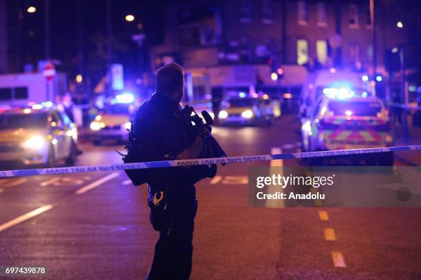 Police take security measures after a vehicle plowed into pedestrians on the sidewalk near the Finsbury Park Mosque on Seven Sisters Road in London,...