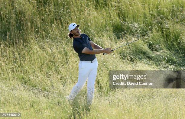 Tommy Fleetwood of England plays his second shot at the par 5, 18th hole during the final round of the 117th US Open Championship at Erin Hills on...