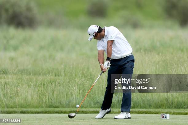 Hideki Matsuyama of Japan plays his tee shot at the par 4, second hole during the final round of the 117th US Open Championship at Erin Hills on June...