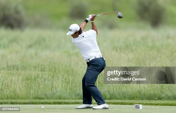 Hideki Matsuyama of Japan plays his tee shot at the par 4, second hole during the final round of the 117th US Open Championship at Erin Hills on June...