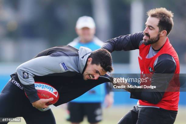 Steele Sidebottom of the Magpies tackles Scott Pendlebury during a Collingwood Magpies AFL training session at Gosch's Paddock on June 19, 2017 in...