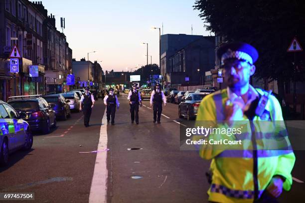 Police officers guard a road leading to Finsbury Park Mosque after an incident in which a van hit worshippers outside the building on June 19, 2017...