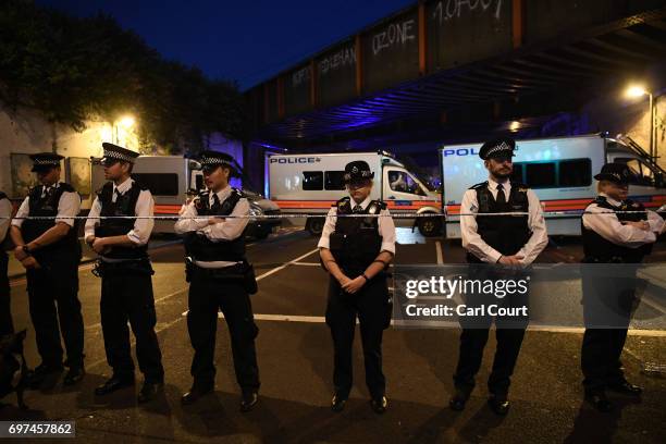 Police officers guard a road leading to Finsbury Park Mosque after an incident in which a van hit worshippers outside the building on June 19, 2017...