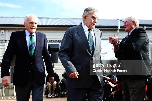 Former All Blacks players Stan Meads and Sir Colin Meads is applauded by Sir Brian Lochore after the unveiling of a new statue on June 19, 2017 in Te...