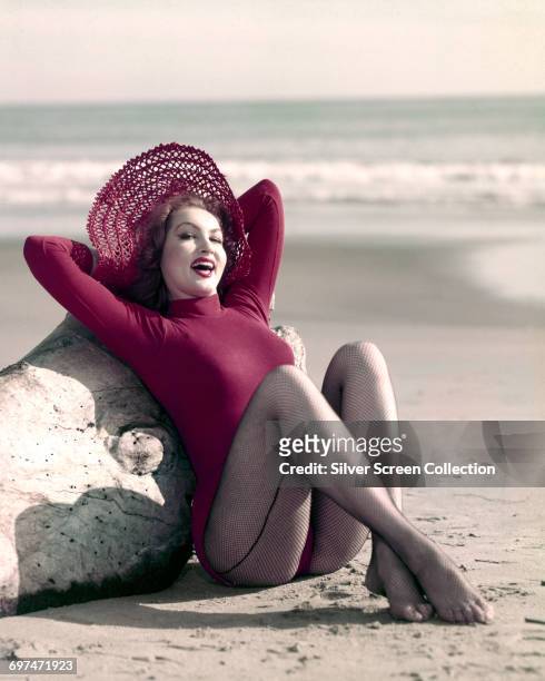 American actress Julie Newmar poses on the beach, circa 1960.