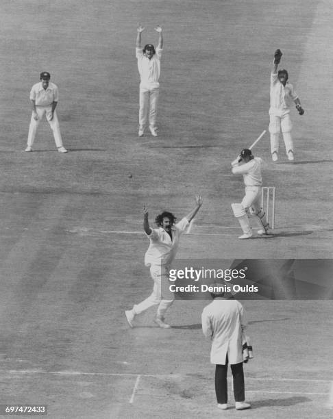 Umpire Dickie Bird looks on as Australian fast bowler Dennis Lillee, wicket keeper Rodney Marsh with slips Greg and Ian Chappell appeal for a leg...