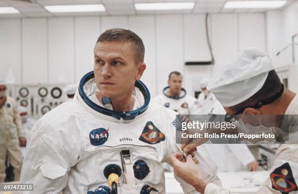 Astronaut and Apollo 8 Commander, Frank Borman receives attention and pre-launch checks from a technician prior to launch and blast off of the Apollo...