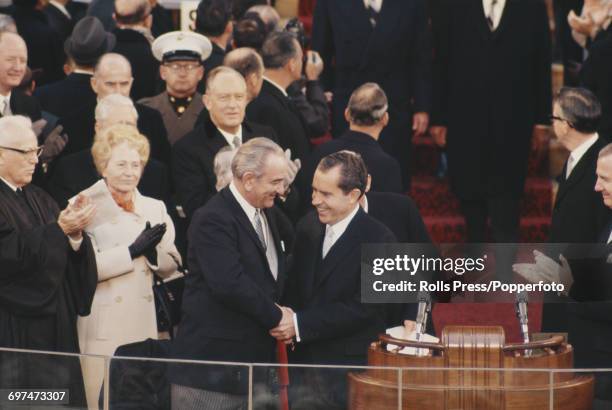 Recently elected 37th President of the United States, Richard Nixon pictured right shaking hands with outgoing President of the United States, Lyndon...